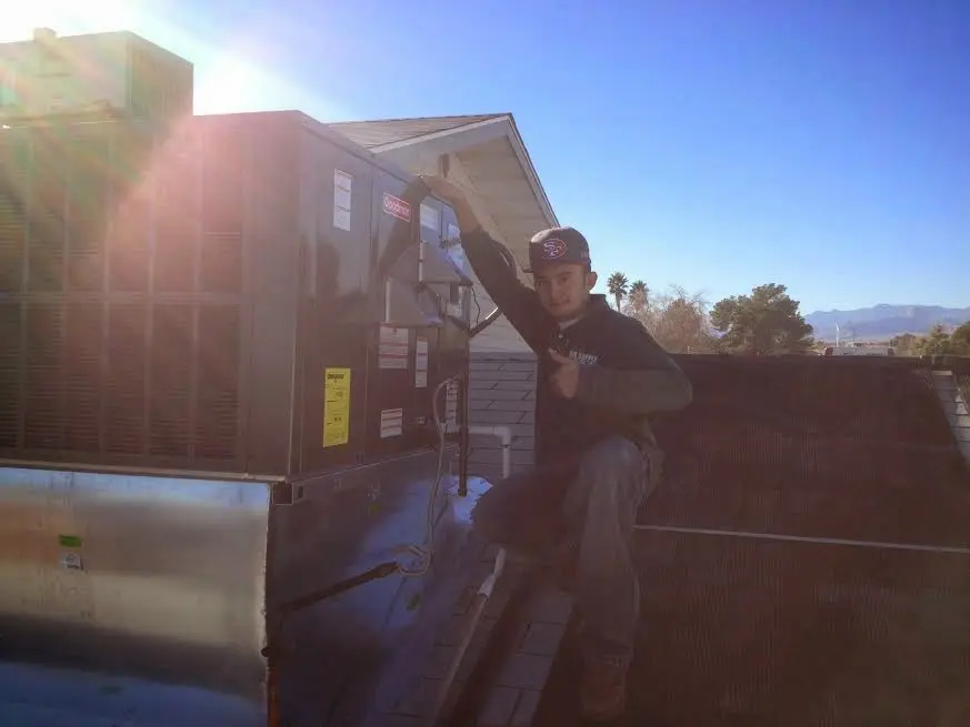 HVAC technician performing Boiler Repair on a rooftop unit in Lochearn